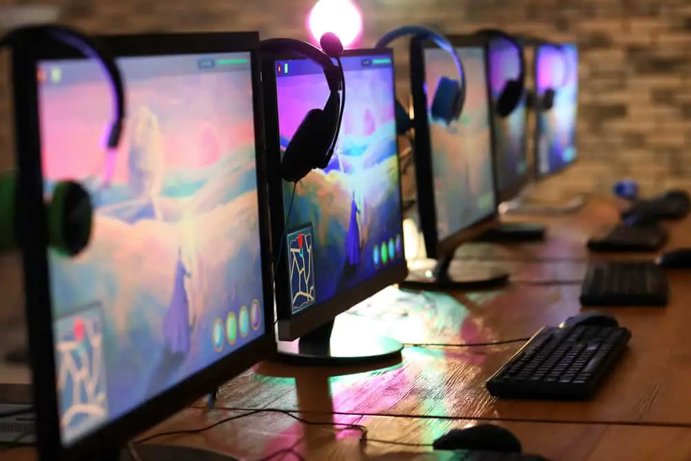 Computer monitors for video games tournament on table